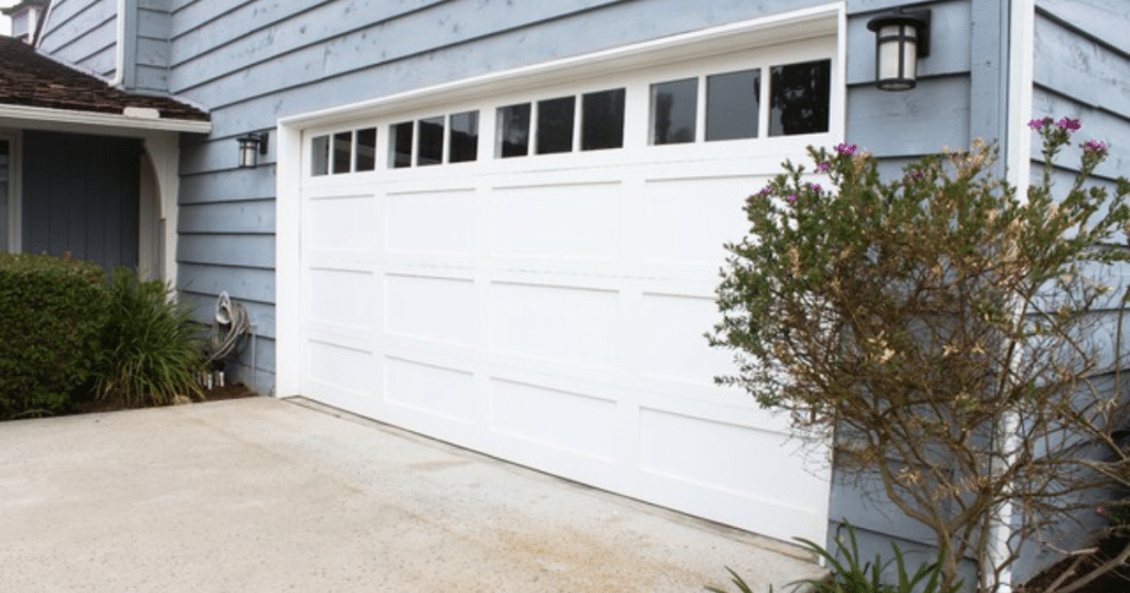White garage door with top glass panels.