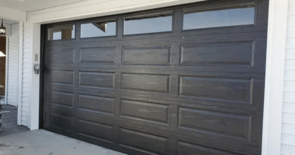 Black garage door with windows on top.